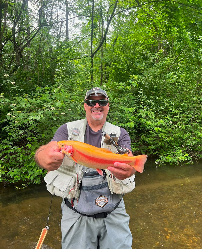 Maddie's dad with rainbow trout in Pennsylvania.